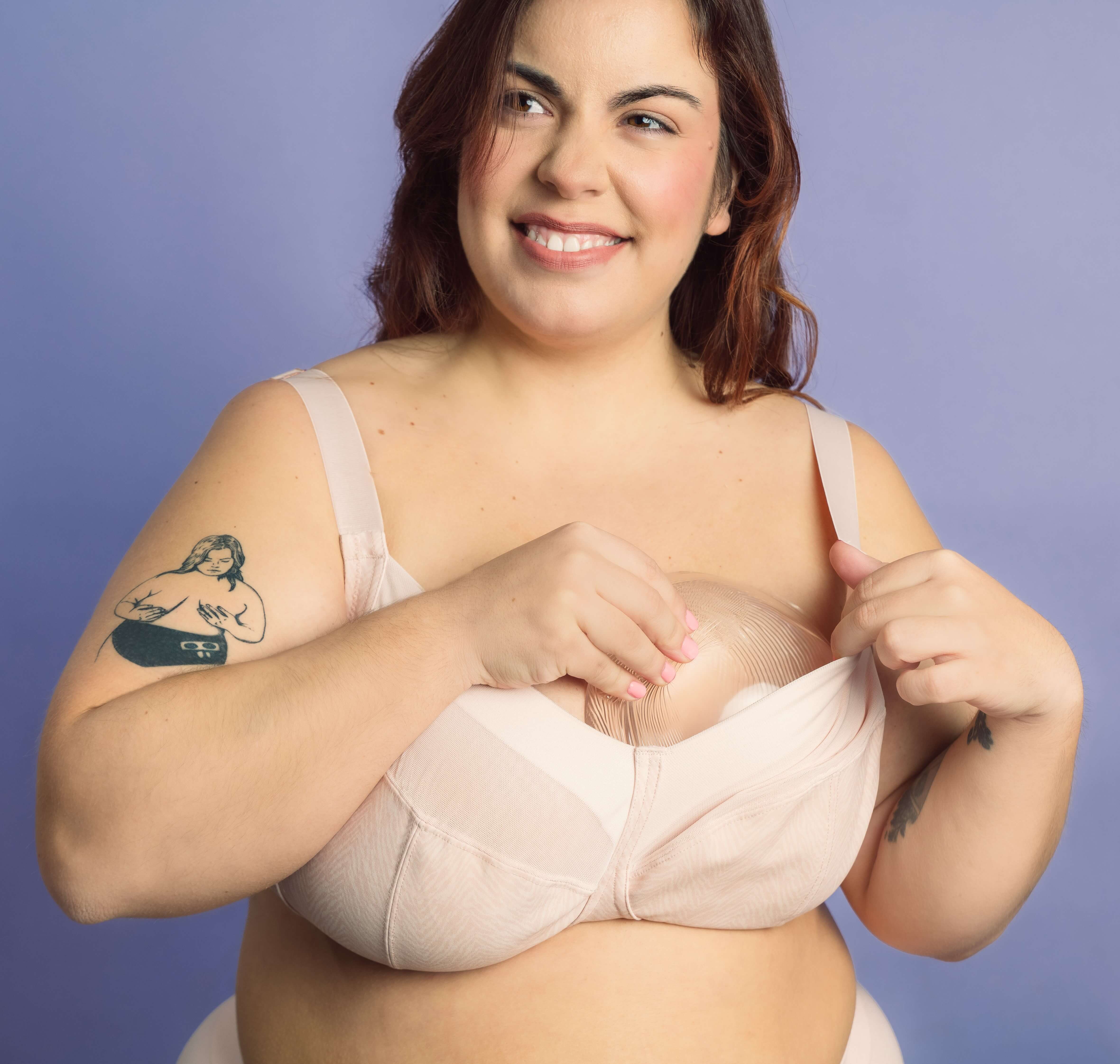 Woman wearing a beige bra against a purple background using bra insert for uneven breast